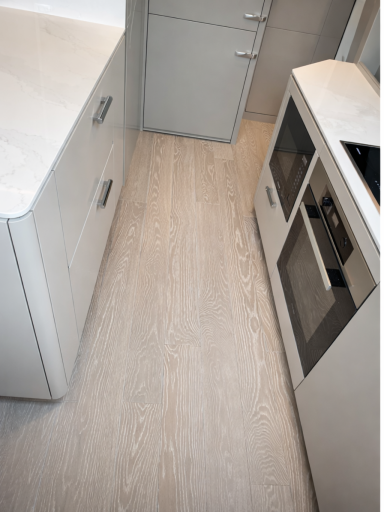 Modern kitchen refurbishment with light oak flooring and fitted units in a Dorset home