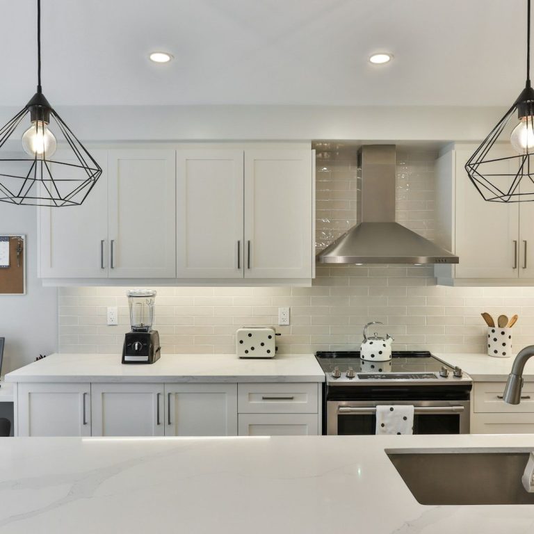 Renovated kitchen featuring new cabinetry, improved lighting and a practical layout