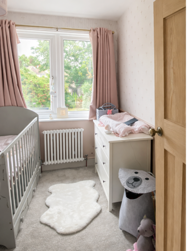 Bright nursery room refurbishment with new flooring, fitted furniture, and natural light in a family home